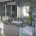 La Villa Des Violettes bathroom in Toulouse with tiled walls, bathtub, sink, and large mirror