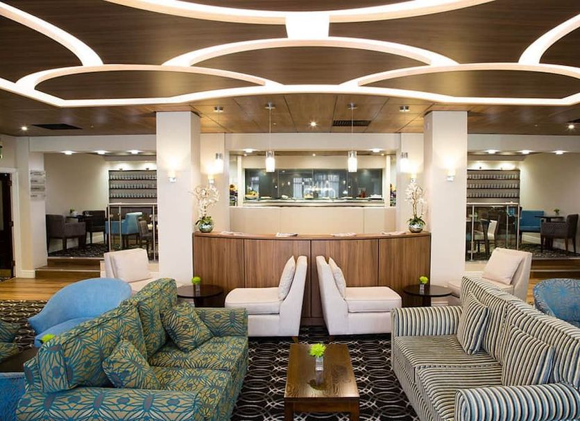 Woodland Grange lobby lounge in Leamington Spa with patterned sofas, armchairs and a reception desk