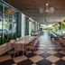 the goodtime hotel, Miami Beach terrace dining area with striped banquette seating and hanging plants