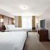 Country Inn & Suites by Radisson, Stillwater, MN guest room with two beds and TV