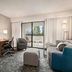 Courtyard by Marriott San Jose South/Morgan Hill guest room with TV, desk, seating area and balcony