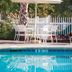 Club Wyndham at The Cottages in Myrtle Beach poolside seating with umbrella beside the pool