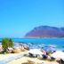 Zorbas Beach Village Hotel in Stavros with beach loungers, umbrellas, and mountain sea views
