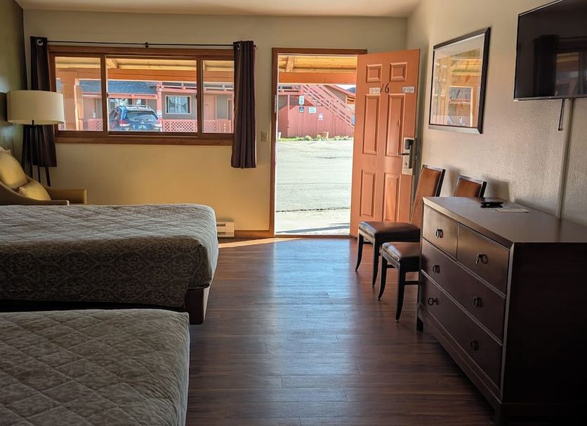 Western Inn Motel & RV Park Fairplay guest room with two beds, dresser, TV, and open door to parking area