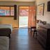 Western Inn Motel & RV Park Fairplay guest room with two beds, dresser, TV, and open door to parking area