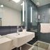 Hanting Hotel Shanghai Xujiahui Metro Station bathroom with glass shower, sink, and toilet in Shanghai