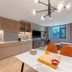 Home2 Suites by Hilton Xishuangbanna Jinghong suite with kitchenette, sofa, dining table and large window