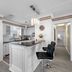 Carousel Suites - Redington Shores kitchen with island, black bar stools and hallway