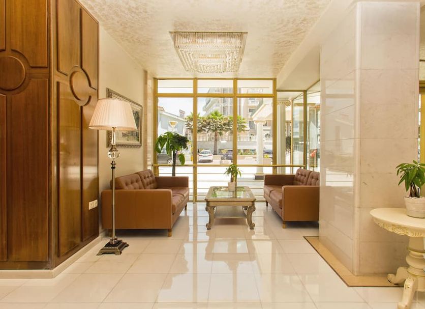Santa Beach Hotel lobby in Agía Triáda with seating, glossy tile floor and large front windows