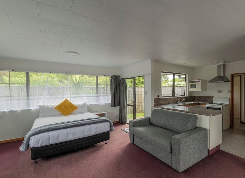 Marton Motel Nz in Marton studio with bed, sofa, kitchenette and large windows