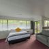 Marton Motel Nz in Marton studio with bed, sofa, kitchenette and large windows