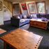 Haka Lodge Christchurch lounge with wood stove, sofas, coffee table and large windows