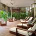 Rosewood Mayakoba in Playa del Carmen with an open-air lounge and cushioned chairs amid tropical greenery