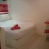 My Home Hotel Kuchai Lama room in Kuala Lumpur with a bed, red table, and stool.