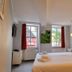 Hotel am Markt, Saarburg guest room with double bed, windows and red curtains