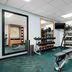 TownePlace Suites by Marriott Fort Walton Beach-Eglin AFB fitness room with weights, bench, and mirrors