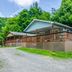 Highland Hills Motel & Cabins in Boone, cabin with covered porch surrounded by trees