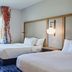 Fairfield Inn & Suites by Marriott Burlington guest room with two beds and a window view