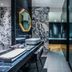 Rivertain Hotel Daegu bathroom with marble walls, double sinks, and glass shower enclosure