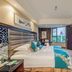 Great Wall Hotel (Yichang Cbd Food Street Store) guest room with twin bed and city view in Yichang