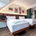 Hotel Schani Uno City Vienna guest room with two twin beds, wood flooring and modern bathroom