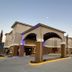 Super 8 by Wyndham Kenedy exterior with covered entrance at dusk in Kenedy