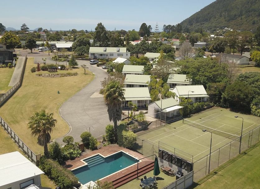 Pauanui Pines Motor Lodge in Pauanui Beach with pool, tennis court, and mountain views