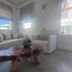 Anna-Maria Mykonos Hotel lounge with white sofa, armchair, wood coffee table and mountain view