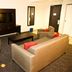 Holiday Inn & Suites Red Deer South living area with sofa, chairs, coffee table and TV