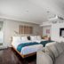 The Knot Tokyo Shinjuku guest room with twin beds, sofa, wall-mounted TV, and large window