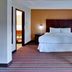 Four Points by Sheraton Nashville Airport guest room with king bed and bedside lamps