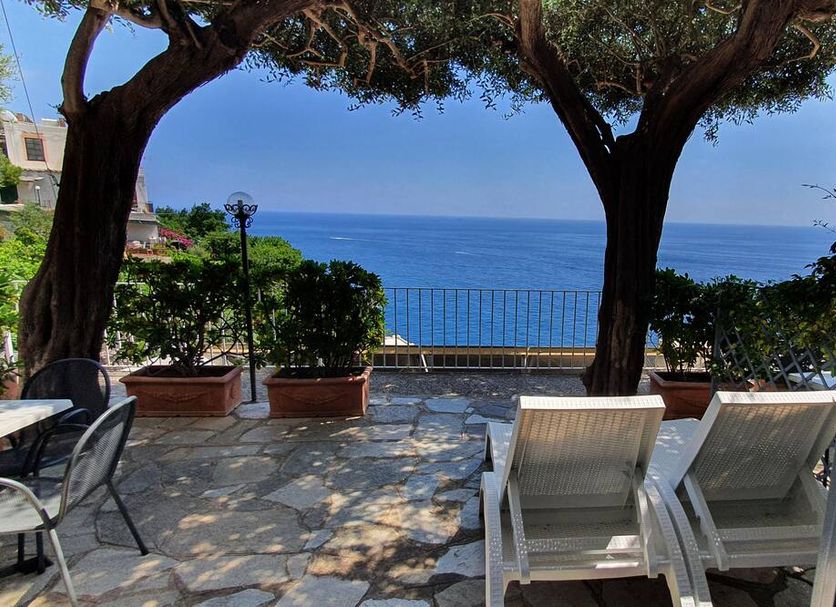 La Maliosa D' Arienzo in Positano with a sea-view terrace and lounge chairs under trees