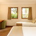 Fitzherbert Castle Motel, Palmerston North: twin beds, wall TV and window view in a simple guest room