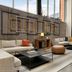 The Casso, Raleigh, a Tribute Portfolio Hotel lobby with sectional seating, staircase and tall windows