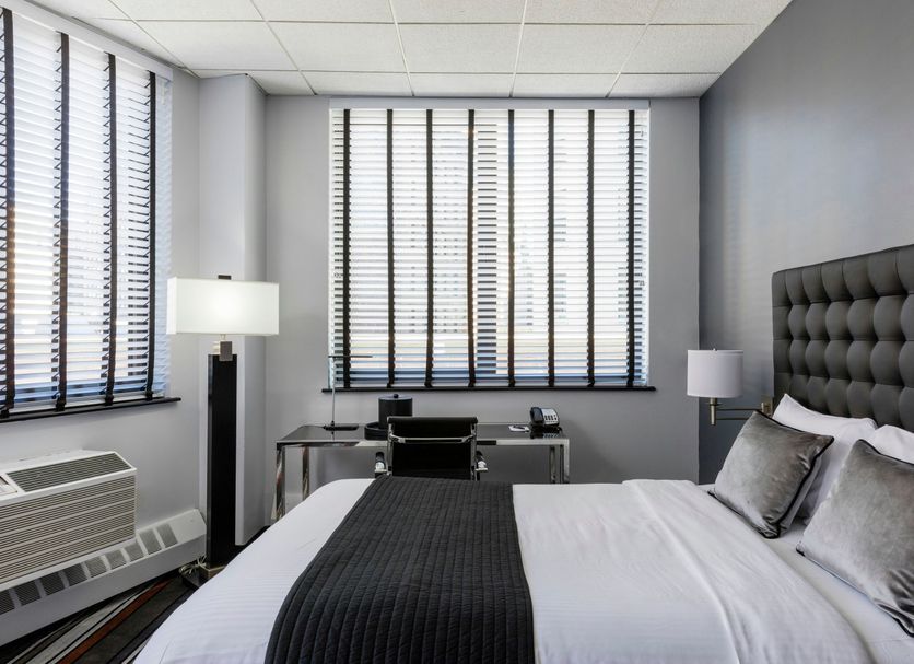 Broadway Plaza Hotel New York guest room with king bed, desk and city-view windows