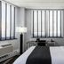 Broadway Plaza Hotel New York guest room with king bed, desk and city-view windows