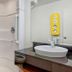 Motel 6 Santa Rosa Nm bathroom with walk-in shower, toilet, and vessel sink in Santa Rosa