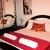 Villa Ambra B&B in Noto: double bed with red runner, rolled towels, and mirrored wardrobe in guest room