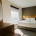 Hyatt Place Augusta guest room with king bed, window light, and city view