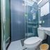 Hi Inn Shanghai Hongqiao Railway Station bathroom with shower, toilet, sink, and blue tiled walls