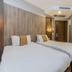Royal Capital Thermal & Spa Hotel in Bursa guest room with two beds and wall-mounted TV