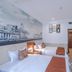 East Garden Hotel Chongqing guest room with twin beds, wall mural, and wall-mounted TV