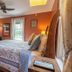 The Stella Rose B&B in Wolfville: cozy guest room with floral bedspread, orange walls and window
