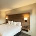 Baymont by Wyndham Lake Park Valdosta I75 guest room with king bed and vanity in Lake Park