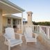 Isola Bella Guest House in Knysna terrace with white chairs and valley view