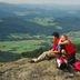 Hotel Amberger Hof in Bad Kotzting with hikers sitting on a rocky overlook above a green valley