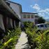 Pousada Fortaleza in Paraty courtyard with parked car, landscaped path and white buildings