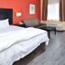 La Bonita Inn & Suites - Mccamey guest room with king bed, sofa, lamp and window in McCamey