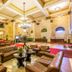Grande Hotel e Termas de Araxá lobby with leather seating, chandelier, and marble floors in Araxá
