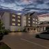 Country Inn & Suites by Radisson Princeton, WV exterior at dusk with parking lot and covered entrance